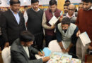 Union Fertilizers Minister Dr Mansukh Mandaviya signs copies of his book "Fertilising The Future” at World Book Fair